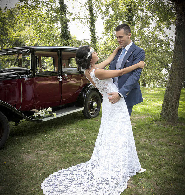 Krystal en déséquilibre arriere enlacée par son mari Aurélien devant une vieille voiture rouge au lac d'Ardres