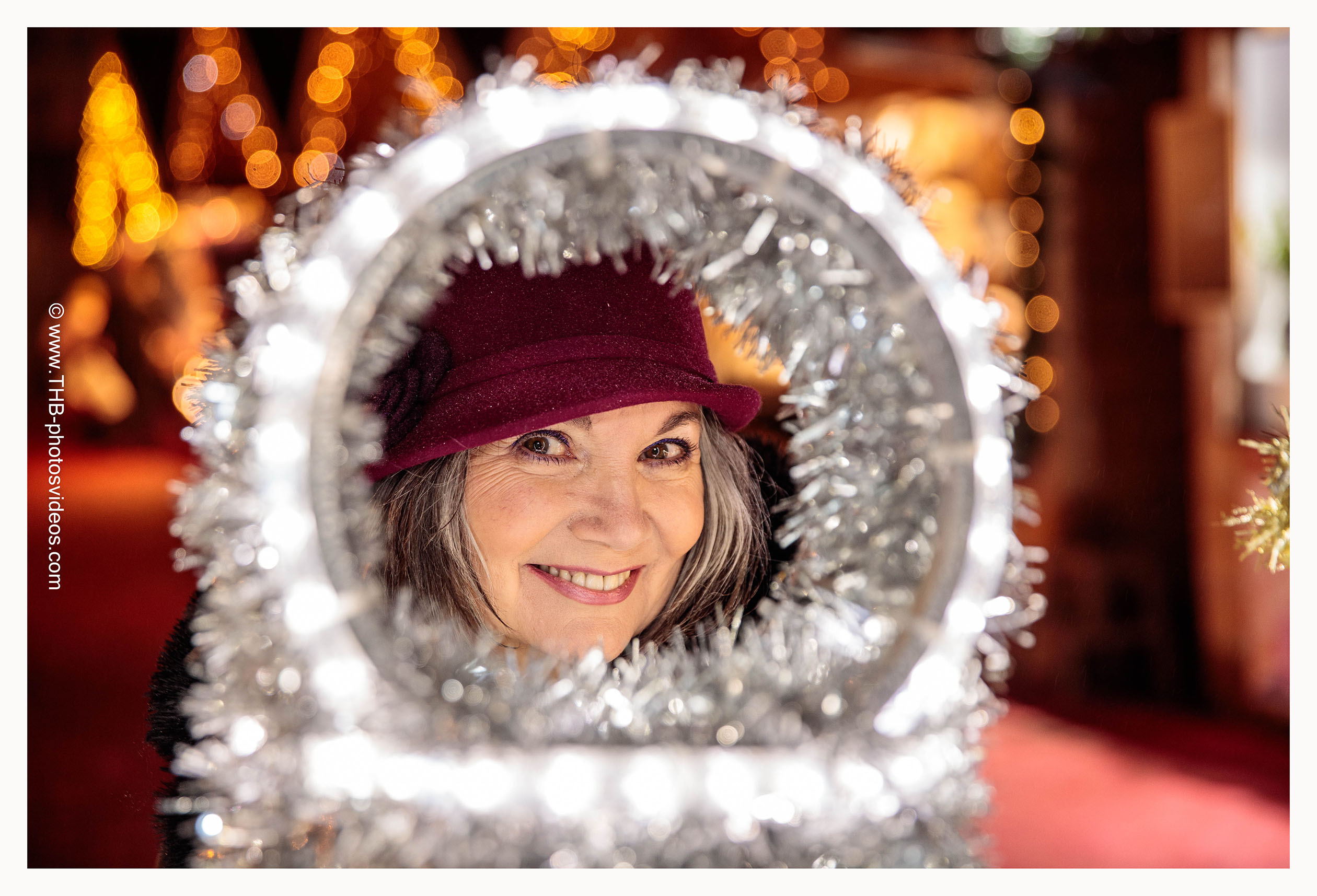 KRYSTNOEL24_0219 a woman looking through a round silver object